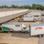 Trucks exiting warehouse bays at 7801 Sears Boulevard in Pensacola, a Northwest Florida industrial property.