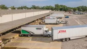 Trucks exiting warehouse bays at 7801 Sears Boulevard in Pensacola, a Northwest Florida industrial property.